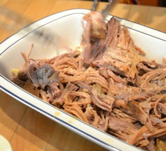tongs-removing-pulled-pork-from-platter